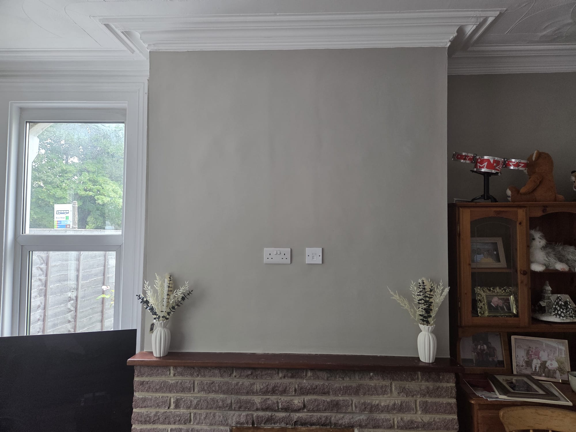 Unfinished residential living room chimney breast before custom painting